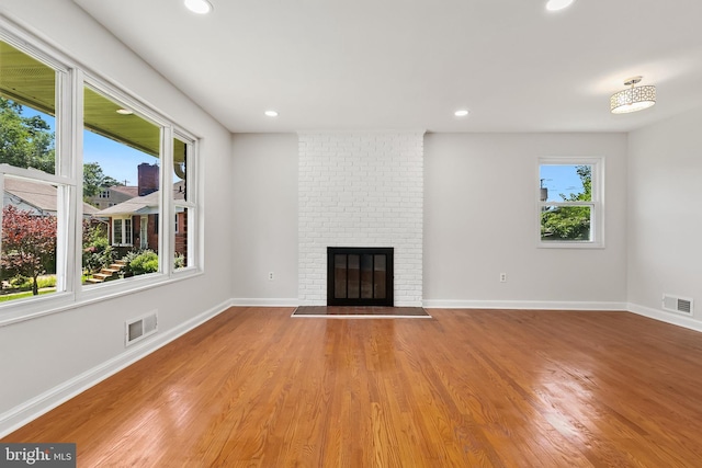 10409 Royalton Ter, Silver Spring, MD 20901 - unfurnished living room featuring a brick fireplace, recessed lighting, and light wood finished floors