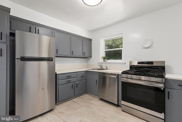 10409 Royalton Ter, Silver Spring, MD 20901 - kitchen with appliances with stainless steel finishes, gray cabinetry, light countertops, and light marble finish flooring