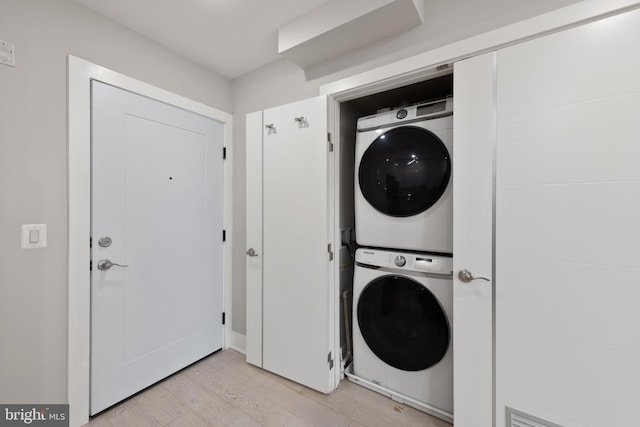1638 K St NE Unit 101, Washington, DC 20002 - washroom with estacked washer and dryer and light wood-type flooring