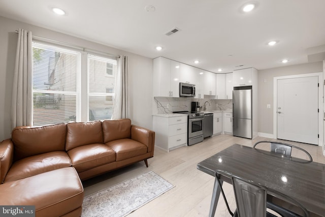 1638 K St NE Unit 101, Washington, DC 20002 - living area with light wood finished floors and recessed lighting