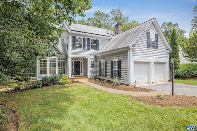 1433 River Oaks Rdg, Charlottesville, VA 22901 - traditional-style house with driveway, solar panels, an attached garage, a front yard, and a chimney