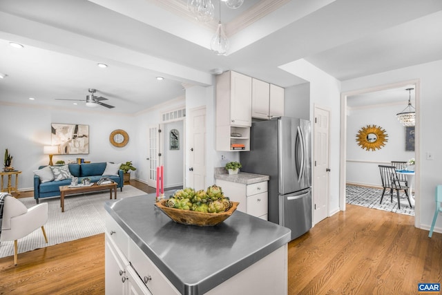 1433 River Oaks Rdg, Charlottesville, VA 22901 - kitchen featuring stainless steel counters, freestanding refrigerator, ornamental molding, white cabinetry, and wood finished floors