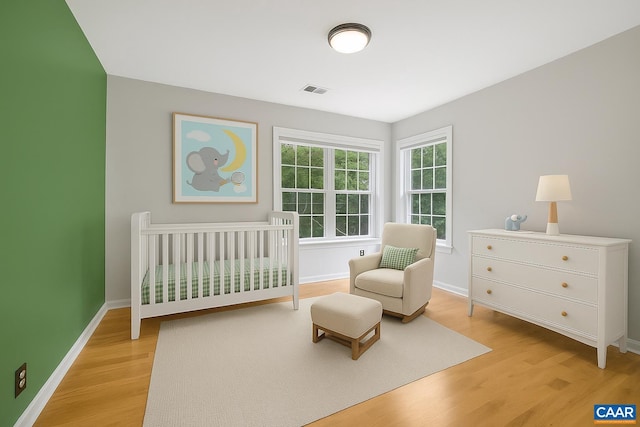 1433 River Oaks Rdg, Charlottesville, VA 22901 - bedroom featuring light wood-style flooring and a nursery area