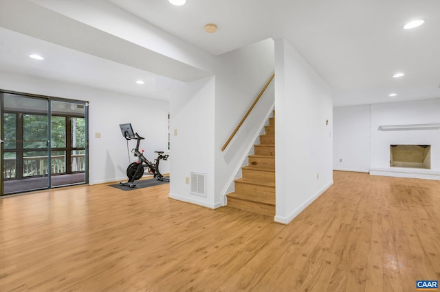 1433 River Oaks Rdg, Charlottesville, VA 22901 - exercise room featuring light wood-style floors, recessed lighting, and a fireplace