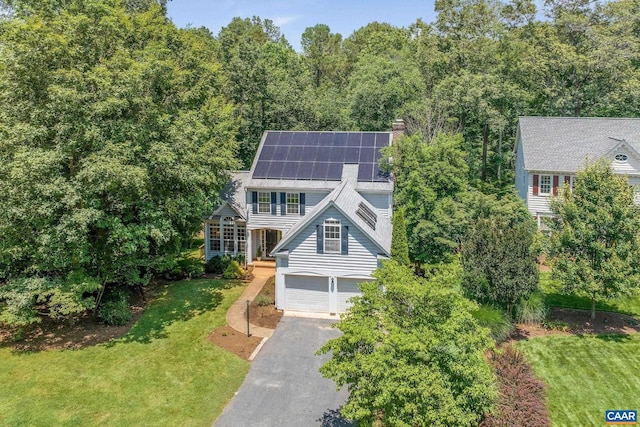 1433 River Oaks Rdg, Charlottesville, VA 22901 - view of front facade featuring asphalt driveway, solar panels, a front lawn, a garage, and a chimney