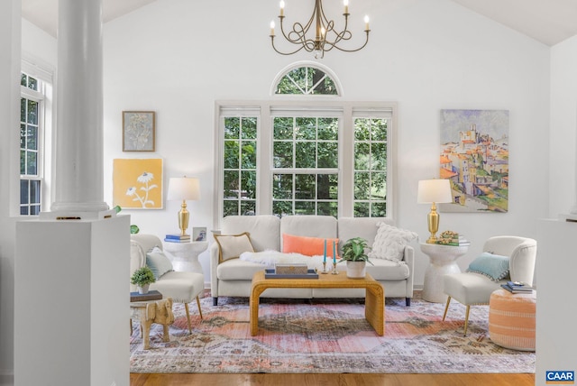 1433 River Oaks Rdg, Charlottesville, VA 22901 - living room with a chandelier, plenty of natural light, decorative columns, high vaulted ceiling, and wood finished floors