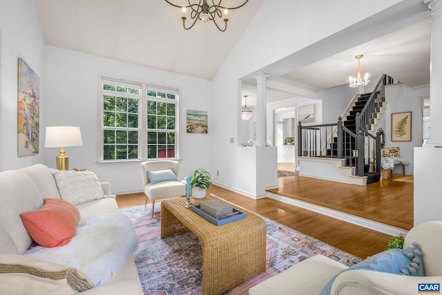 1433 River Oaks Rdg, Charlottesville, VA 22901 - living area featuring a chandelier, stairway, ornate columns, wood finished floors, and lofted ceiling