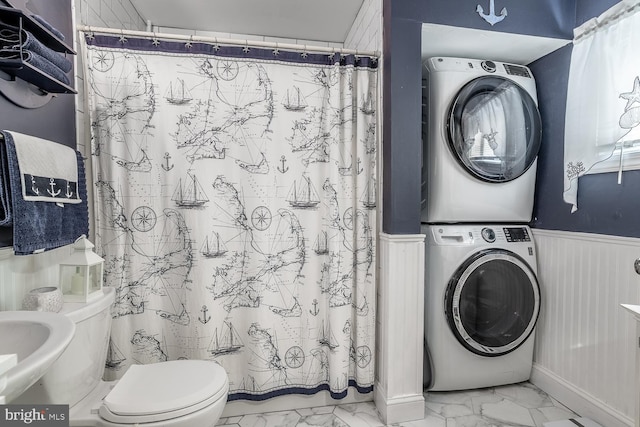 24 Paul Rd, Maple Shade, NJ 08052 - bathroom featuring stacked washer and clothes dryer, marble finish floors, wainscoting, and a shower with shower curtain