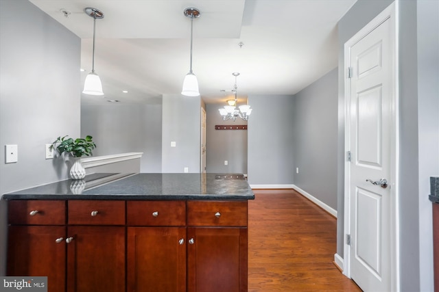 4163 S Four Mile Run Dr Unit 401, Arlington, VA 22204 - kitchen with a peninsula, dark wood-style flooring, pendant lighting, a chandelier, and dark stone counters