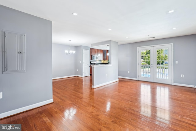 4163 S Four Mile Run Dr Unit 401, Arlington, VA 22204 - unfurnished living room with a chandelier, wood finished floors, recessed lighting, and electric panel