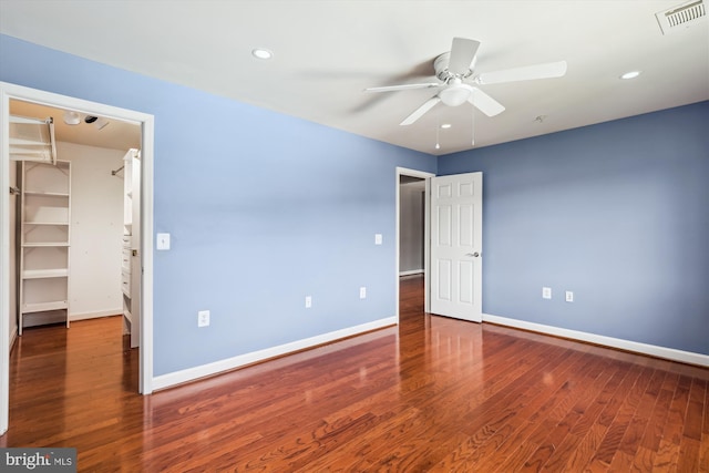 4163 S Four Mile Run Dr Unit 401, Arlington, VA 22204 - unfurnished bedroom featuring a walk in closet, wood finished floors, a closet, recessed lighting, and ceiling fan