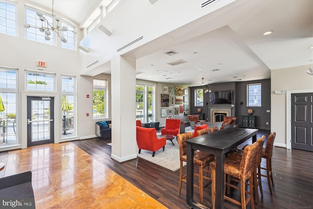 4163 S Four Mile Run Dr Unit 401, Arlington, VA 22204 - dining space featuring plenty of natural light, a fireplace, and wood finished floors