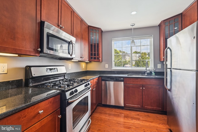 4163 S Four Mile Run Dr Unit 401, Arlington, VA 22204 - kitchen with appliances with stainless steel finishes, wood finished floors, recessed lighting, pendant lighting, and reddish brown cabinets