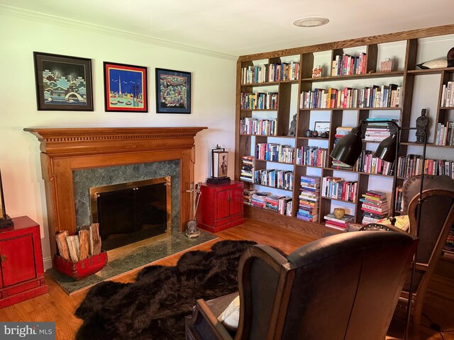 7071 Pomona Rd, Chestertown, MD 21620 - sitting room featuring wood finished floors, a fireplace, and ornamental molding