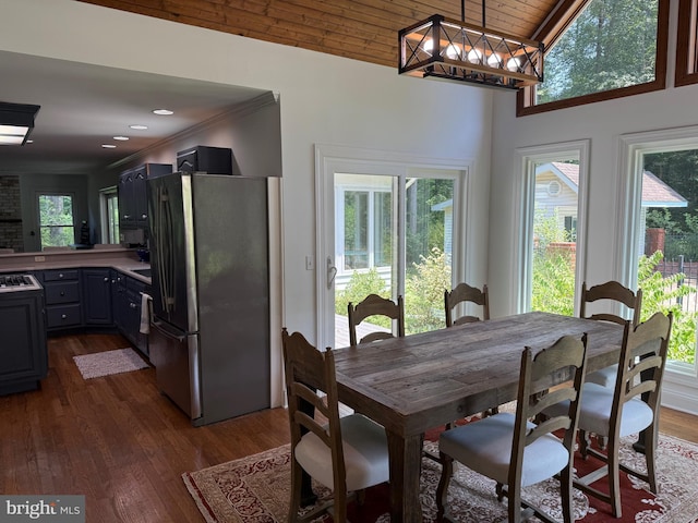 7071 Pomona Rd, Chestertown, MD 21620 - dining space featuring dark wood-style floors, crown molding, and vaulted ceiling