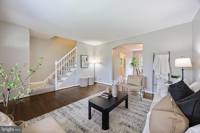 4703 Williston St, Baltimore, MD 21229 - living room with arched walkways, wood finished floors, and stairway