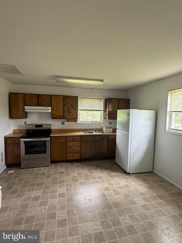434 Anderson Rd, Martinsburg, WV 25404 - kitchen with stainless steel electric range, freestanding refrigerator, light countertops, and under cabinet range hood