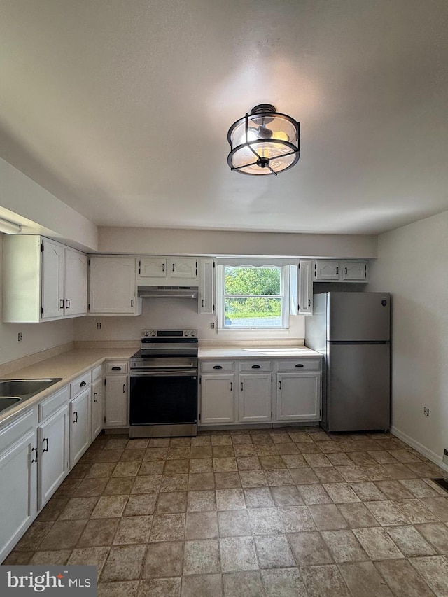 434 Anderson Rd, Martinsburg, WV 25404 - kitchen featuring stainless steel electric range oven, freestanding refrigerator, under cabinet range hood, and light stone finish flooring
