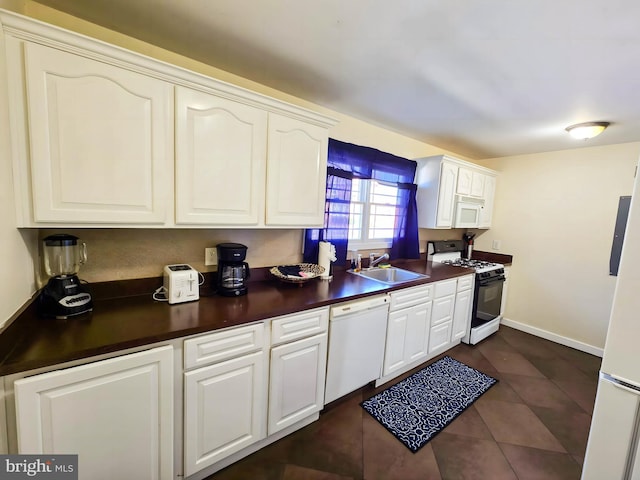 102 Red Lion Rd, Southampton, NJ 08088 - kitchen with white appliances, dark countertops, dark tile patterned flooring, and white cabinets