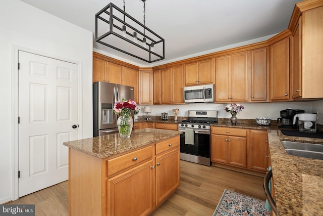 17 Saint Claires Ct, Stafford, VA 22556 - kitchen featuring stainless steel appliances, light wood-type flooring, dark stone countertops, and brown cabinets