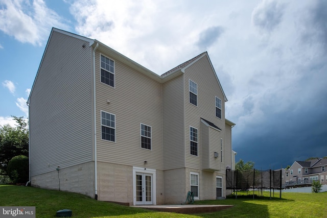 17 Saint Claires Ct, Stafford, VA 22556 - back of house with french doors, a yard, and a trampoline