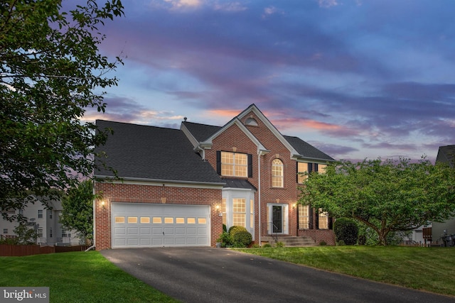 17 Saint Claires Ct, Stafford, VA 22556 - view of front facade featuring brick siding, asphalt driveway, a yard, an attached garage, and a shingled roof