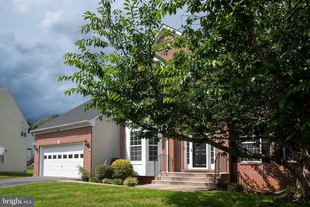 17 Saint Claires Ct, Stafford, VA 22556 - obstructed view of property featuring brick siding, entry steps, an attached garage, a front lawn, and driveway