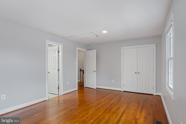 9518 Unity Ln, Lorton, VA 22079 - unfurnished bedroom featuring wood finished floors, a closet, attic access, multiple windows, and recessed lighting