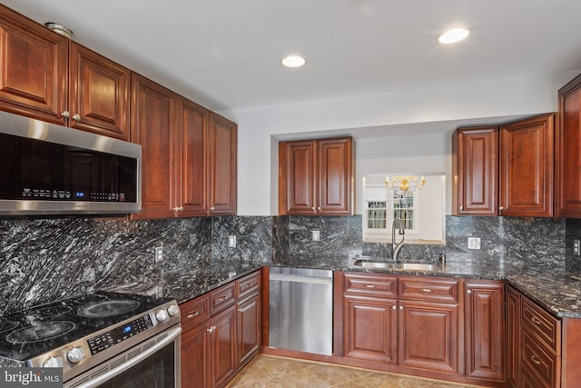 9518 Unity Ln, Lorton, VA 22079 - kitchen with appliances with stainless steel finishes, dark stone countertops, backsplash, recessed lighting, and light tile patterned floors