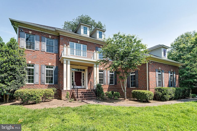 10002 Courthouse Rd, Vienna, VA 22181 - colonial inspired home with brick siding, a front yard, and a balcony