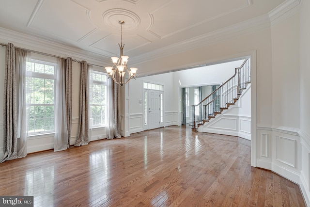 10002 Courthouse Rd, Vienna, VA 22181 - unfurnished room featuring a decorative wall, a chandelier, stairs, ornamental molding, and light wood-style flooring