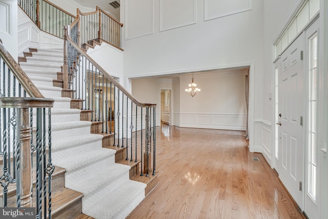 10002 Courthouse Rd, Vienna, VA 22181 - entrance foyer with a towering ceiling, a chandelier, a decorative wall, stairs, and crown molding