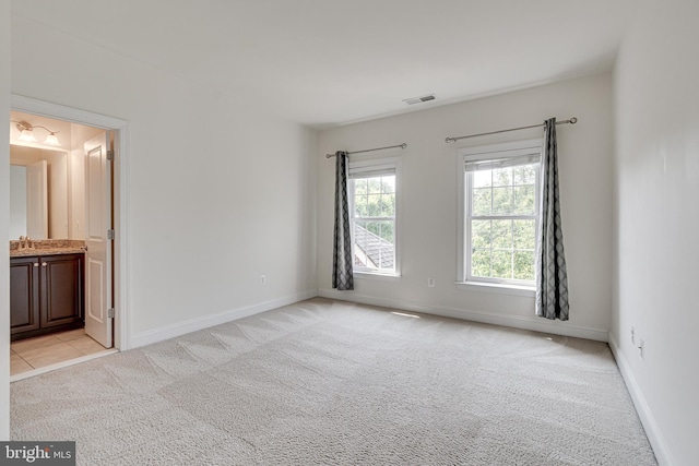 10002 Courthouse Rd, Vienna, VA 22181 - unfurnished bedroom featuring multiple windows, light carpet, and ensuite bathroom