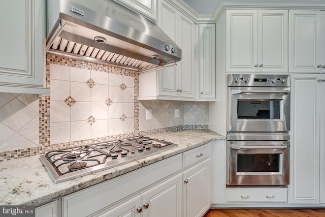 10002 Courthouse Rd, Vienna, VA 22181 - kitchen with exhaust hood, stainless steel appliances, tasteful backsplash, and white cabinets