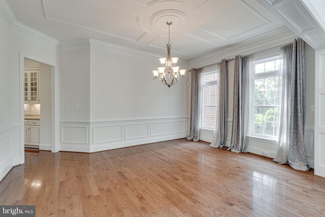 10002 Courthouse Rd, Vienna, VA 22181 - spare room featuring a chandelier, a decorative wall, light wood-type flooring, crown molding, and wainscoting