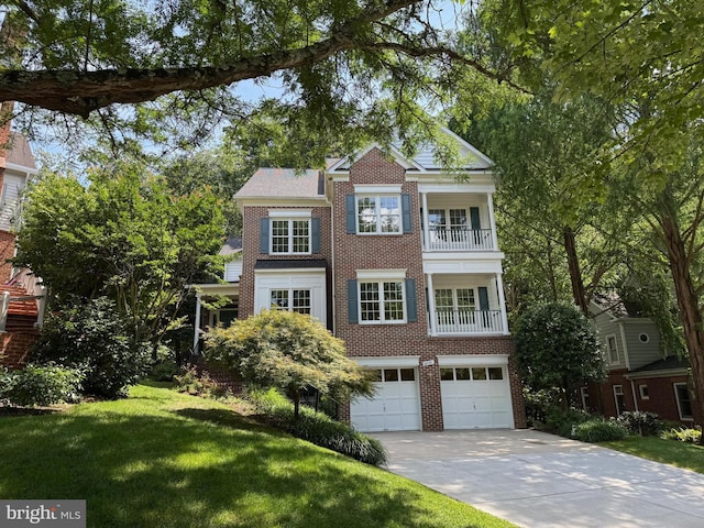 8010 Ellingson Dr, Chevy Chase, MD 20815 - view of front of home featuring driveway, a garage, brick siding, a balcony, and a front yard
