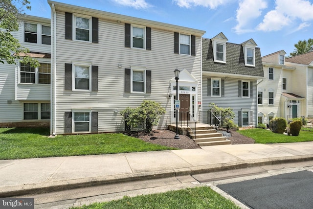 20315 Beaconfield Ter Unit 202, Germantown, MD 20874 - view of front of home with a front yard and roof with shingles