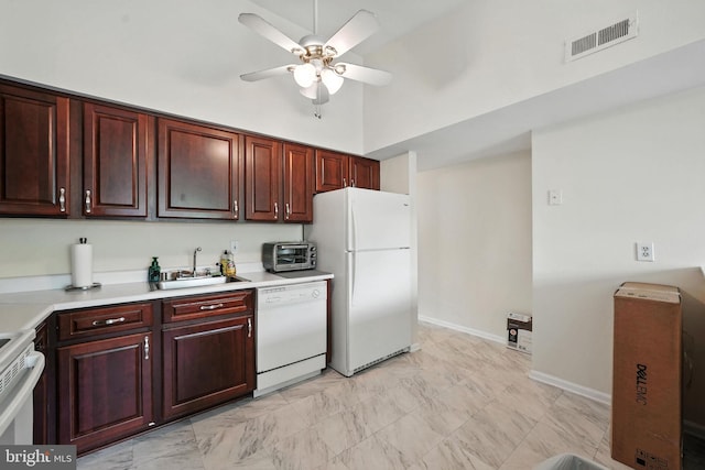 20315 Beaconfield Ter Unit 202, Germantown, MD 20874 - kitchen with white appliances, ceiling fan, light countertops, reddish brown cabinets, and a high ceiling