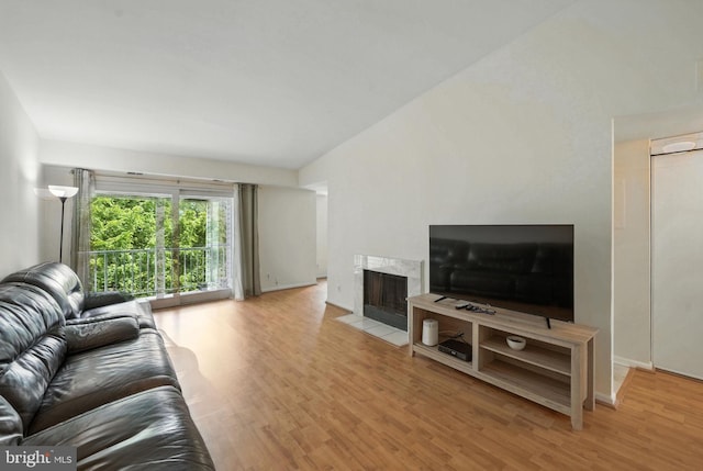 20315 Beaconfield Ter Unit 202, Germantown, MD 20874 - living area with lofted ceiling, wood finished floors, and a premium fireplace