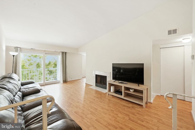 20315 Beaconfield Ter Unit 202, Germantown, MD 20874 - living area featuring light wood-style floors, a fireplace with flush hearth, and lofted ceiling