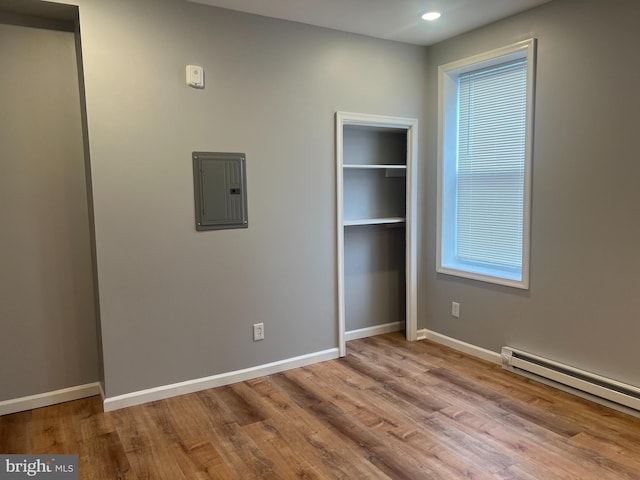 2036 W Ontario St, Philadelphia, PA 19140 - unfurnished bedroom featuring electric panel, baseboard heating, wood finished floors, recessed lighting, and a closet
