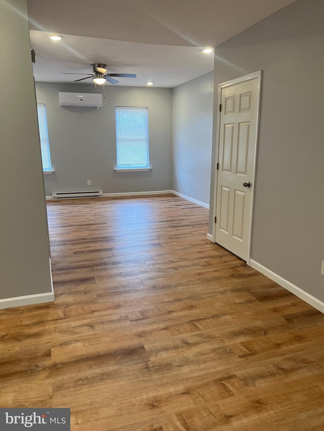 2036 W Ontario St, Philadelphia, PA 19140 - empty room featuring a wall mounted air conditioner, a ceiling fan, a baseboard heating unit, wood finished floors, and recessed lighting