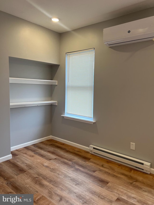 2036 W Ontario St, Philadelphia, PA 19140 - unfurnished dining area with a baseboard radiator, a wall mounted AC, and wood finished floors