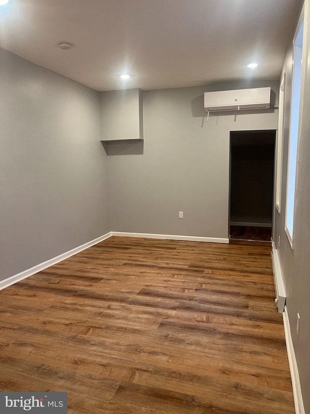 2036 W Ontario St, Philadelphia, PA 19140 - spare room with a wall mounted AC, wood finished floors, a baseboard radiator, and recessed lighting