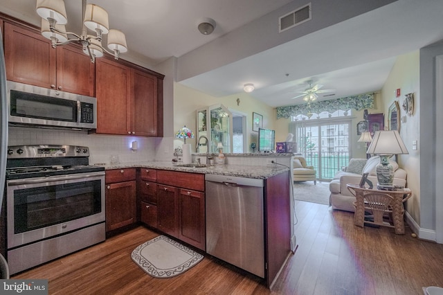 1000 Fountanview Cir, Newark, DE 19713 - kitchen with appliances with stainless steel finishes, a peninsula, open floor plan, a chandelier, and wood finished floors