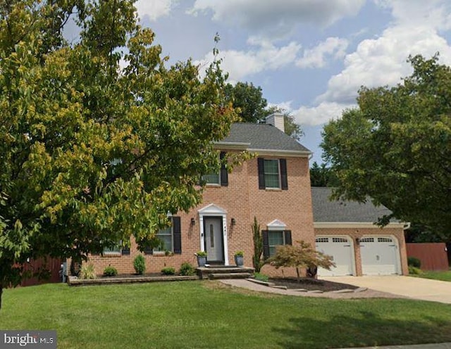 1802 Disney Estates Cir, Severn, MD 21144 - colonial-style house featuring an attached garage, driveway, a front lawn, and brick siding