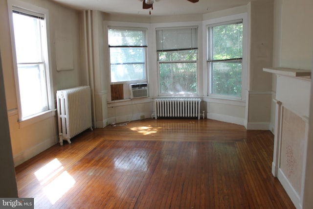 1628 River Rd, Upper Black Eddy, PA 18972 - empty room featuring radiator heating unit, a ceiling fan, hardwood / wood-style flooring, and plenty of natural light