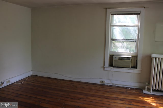 1628 River Rd, Upper Black Eddy, PA 18972 - empty room with radiator, cooling unit, and hardwood / wood-style floors