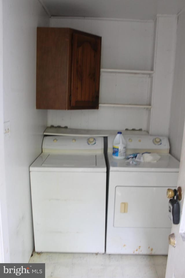 1628 River Rd, Upper Black Eddy, PA 18972 - washroom featuring washer and clothes dryer, cabinet space, and light tile patterned floors