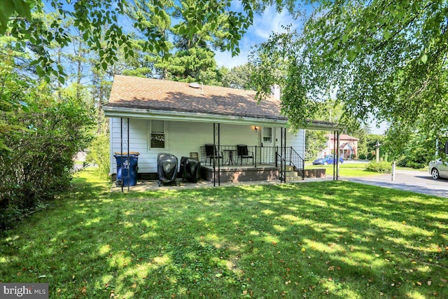 30 N Dwight St, Reading, PA 19609 - rear view of property with a yard and a porch